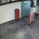 A security camera catches a girl pissing in a parking lot after hours. No audio.